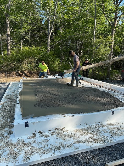 Spreading wet concrete across the slab form