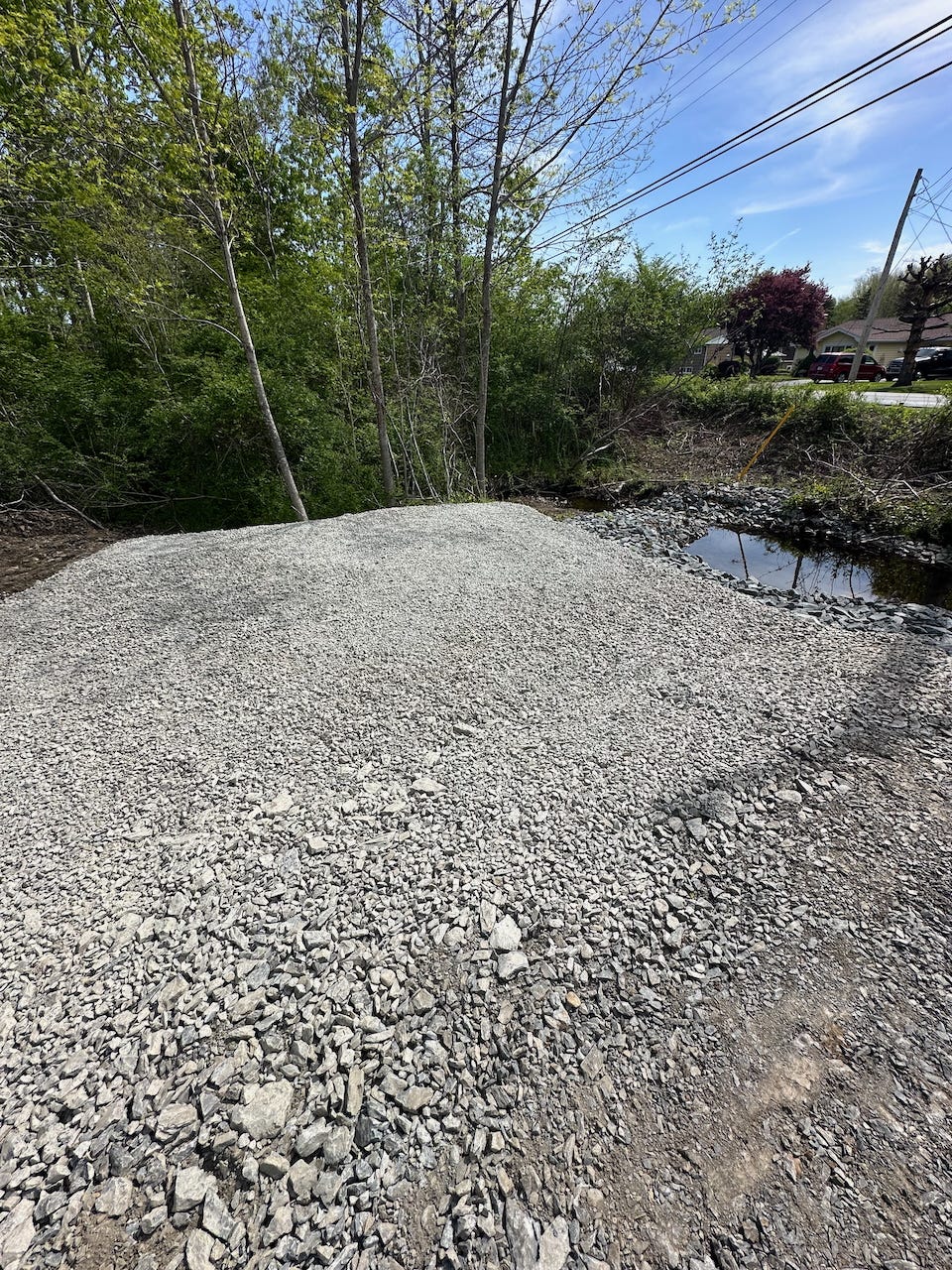The smaller gravel pad, made for 8’x12’ structure (the “power shed”). The pad needs to be ~18’x22’ to accommodate the rigid f