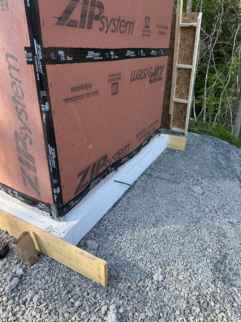 Zip tape attaching the poly vapor barrier at the bottom of the wall to the sheathing.