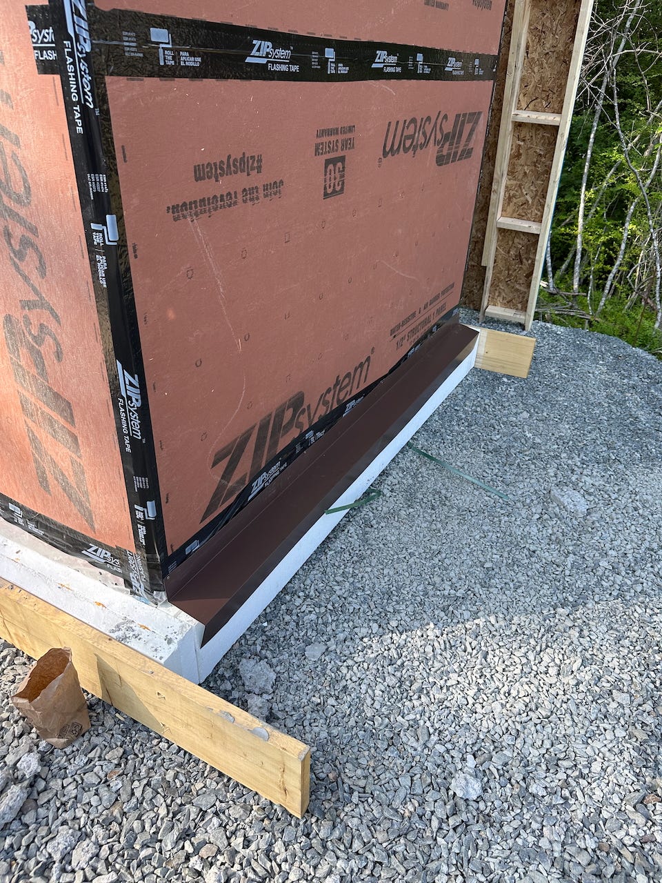 brown metal flashing installed over the foam base