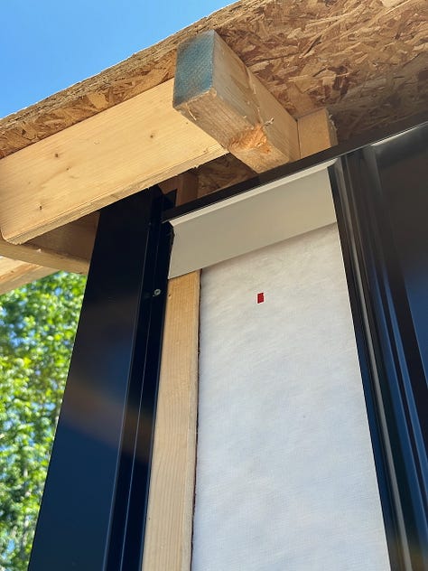 The first pieces of trim and siding being added over the strapping.